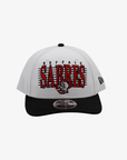 New Era Buffalo Sabres white and black 9FORTY M-Crown adjustable hat featuring red SABRES lettering, retro buffalo head logo, and black curved visor.