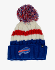 '47 Brand women's Buffalo Bills cable knit beanie featuring royal blue, red, and cream stripes, a multicolor yarn pom, and an embroidered charging buffalo logo on the royal blue cuff.