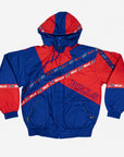 Pro Player Buffalo Bills retro hooded jacket featuring royal blue and red geometric colorblocking, diagonal Bills logo stripes, outlined BILLS lettering, and zippered pockets.