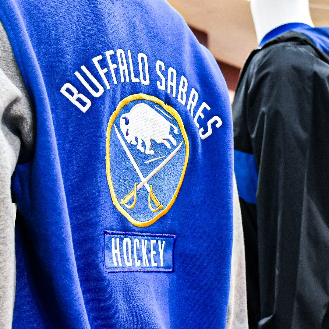 The photo is of two Buffalo Sabres coats. Shop Buffalo Sabres shirt, jackets, coats, mens, and women's products and apparel at the The BFLO Store.