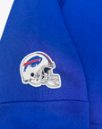 Close-up of a royal blue sweatshirt sleeve featuring an embroidered Buffalo Bills helmet logo patch on the upper arm.