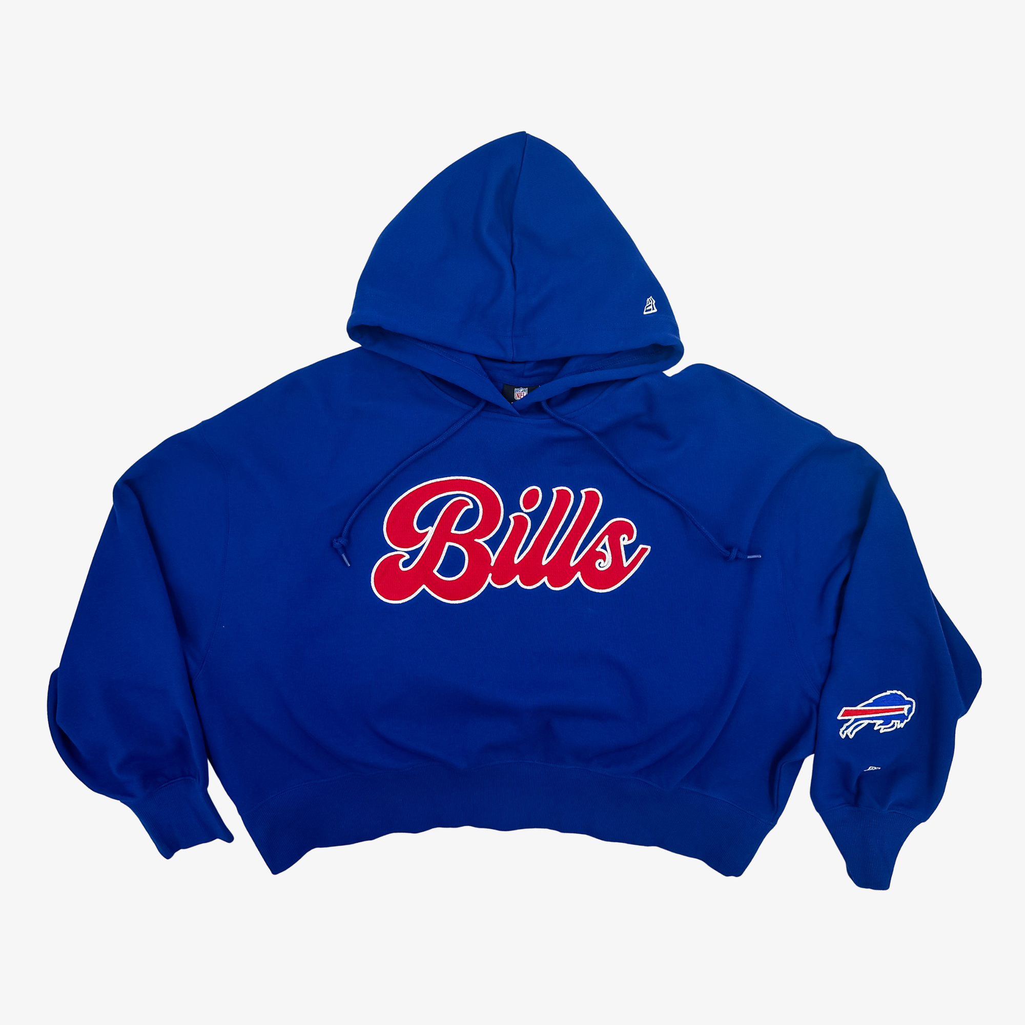 A royal blue cropped hoodie featuring 'Bills' in red cursive script with a white outline across the chest, and a Buffalo Bills logo on the left sleeve, shown against a plain light gray background.