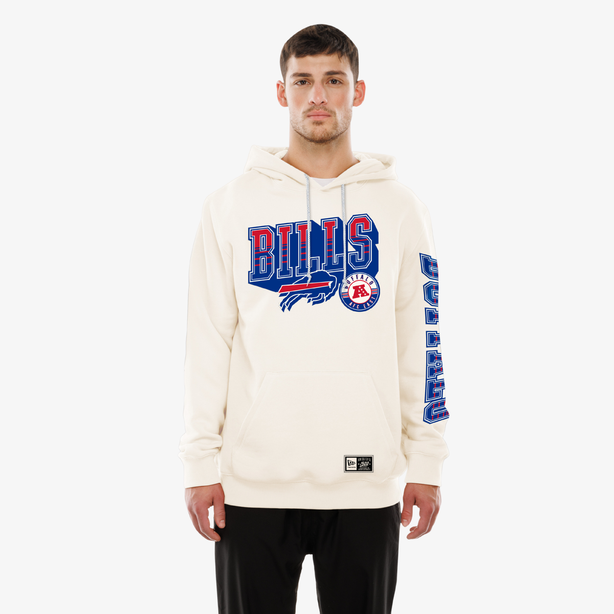 A man modeling an off-white pullover hoodie with Buffalo Bills graphics, including 'BILLS' text, on a light gray background.