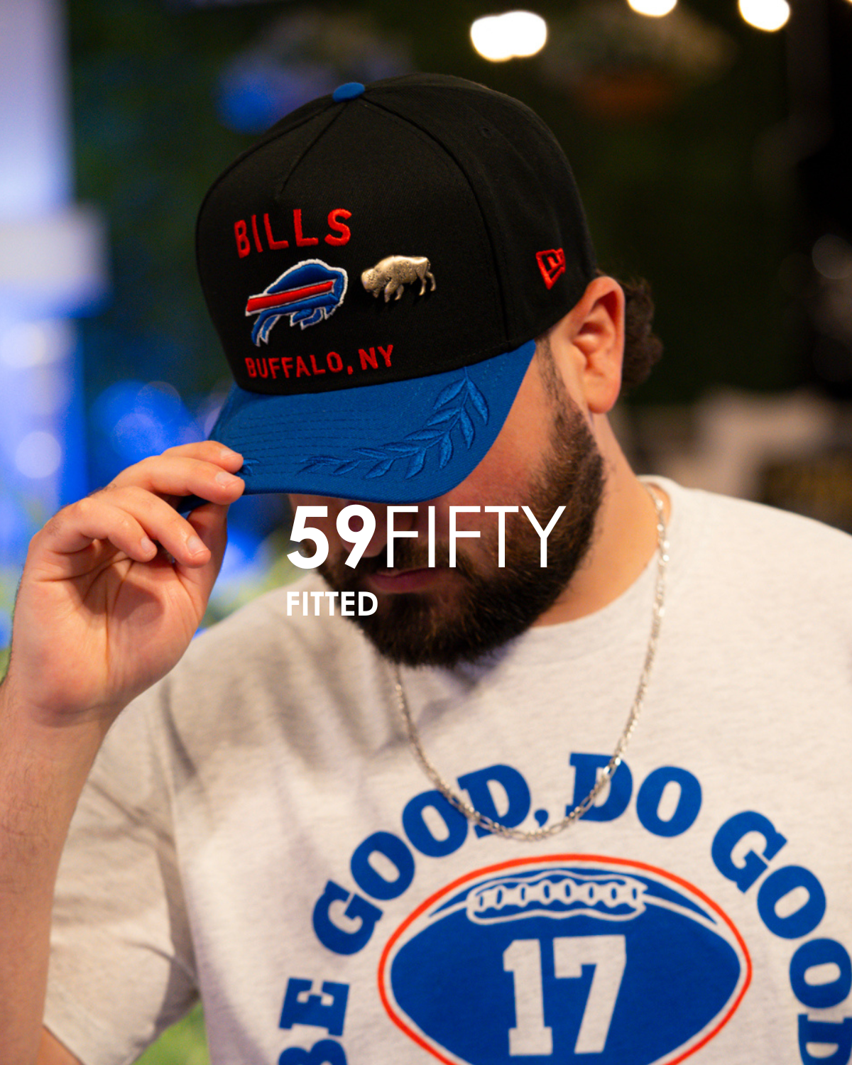 Person wearing a blue and black 'Bills' cap with '59FIFTY FITTED' text, blurred background