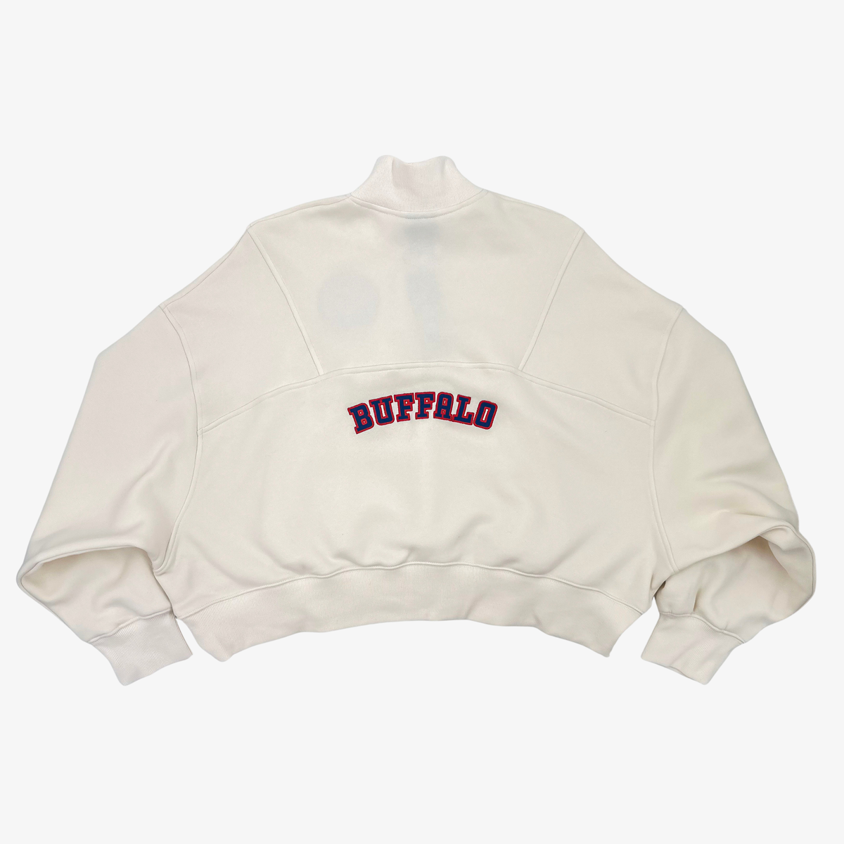 New Era women's Buffalo Bills cream cropped quarter-zip pullover with red and royal blue BUFFALO lettering across the back