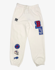 New Era women's Buffalo Bills cream jogger sweatpants with colorful vintage-inspired team patches, drawstring waist and elastic cuffs