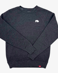 A dark heather black crewneck sweatshirt with a small white rhinoceros logo on the left chest and a small red tag near the bottom hem, displayed on a light gray background.
