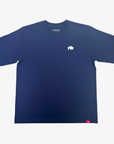 A navy blue short-sleeve crewneck t-shirt with a small white bison logo on the left chest and a small red tag near the bottom hem, displayed flat against a light gray background.