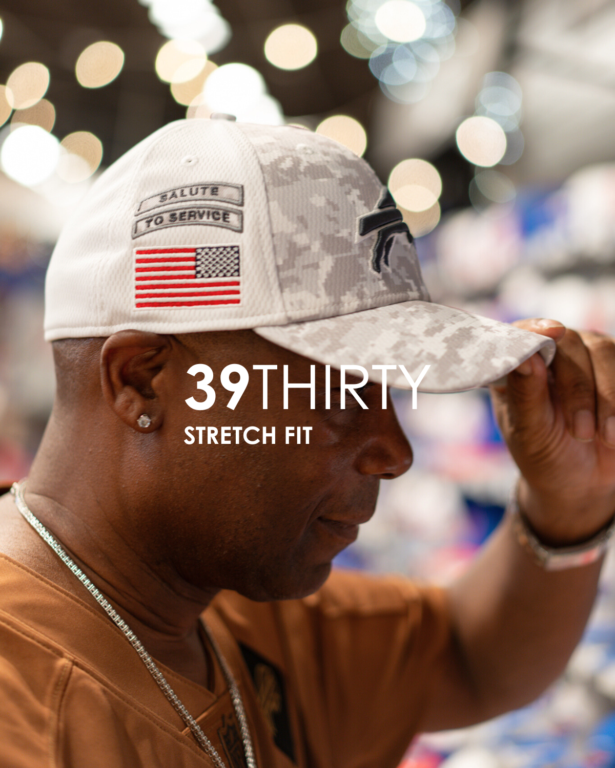 Person wearing a '39THIRTY' stretch fit cap with American flag design, blurred background