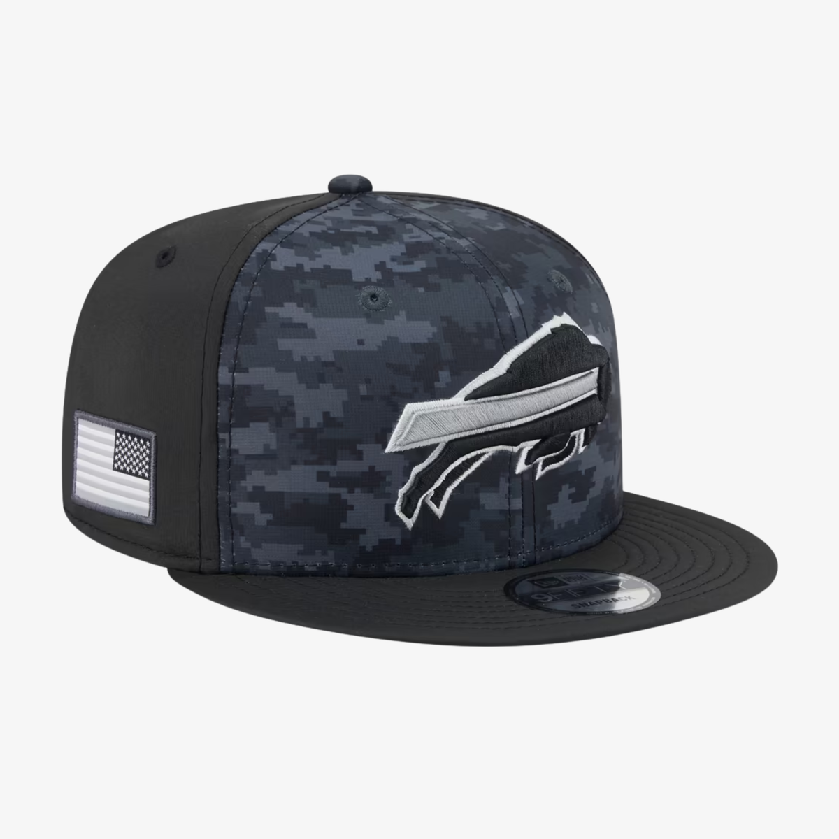 A flat-brim baseball cap featuring a dark digital camouflage pattern on the front panels and a solid black crown and brim. The front displays a white and gray Buffalo Bills charging logo, and the side has a small white American flag patch.