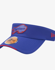 A royal blue visor hat featuring the Buffalo Bills charging buffalo logo embroidered on the front, a red embroidered New Era flag logo on the side, and a gold metallic sticker on the brim, set against a plain light gray background.