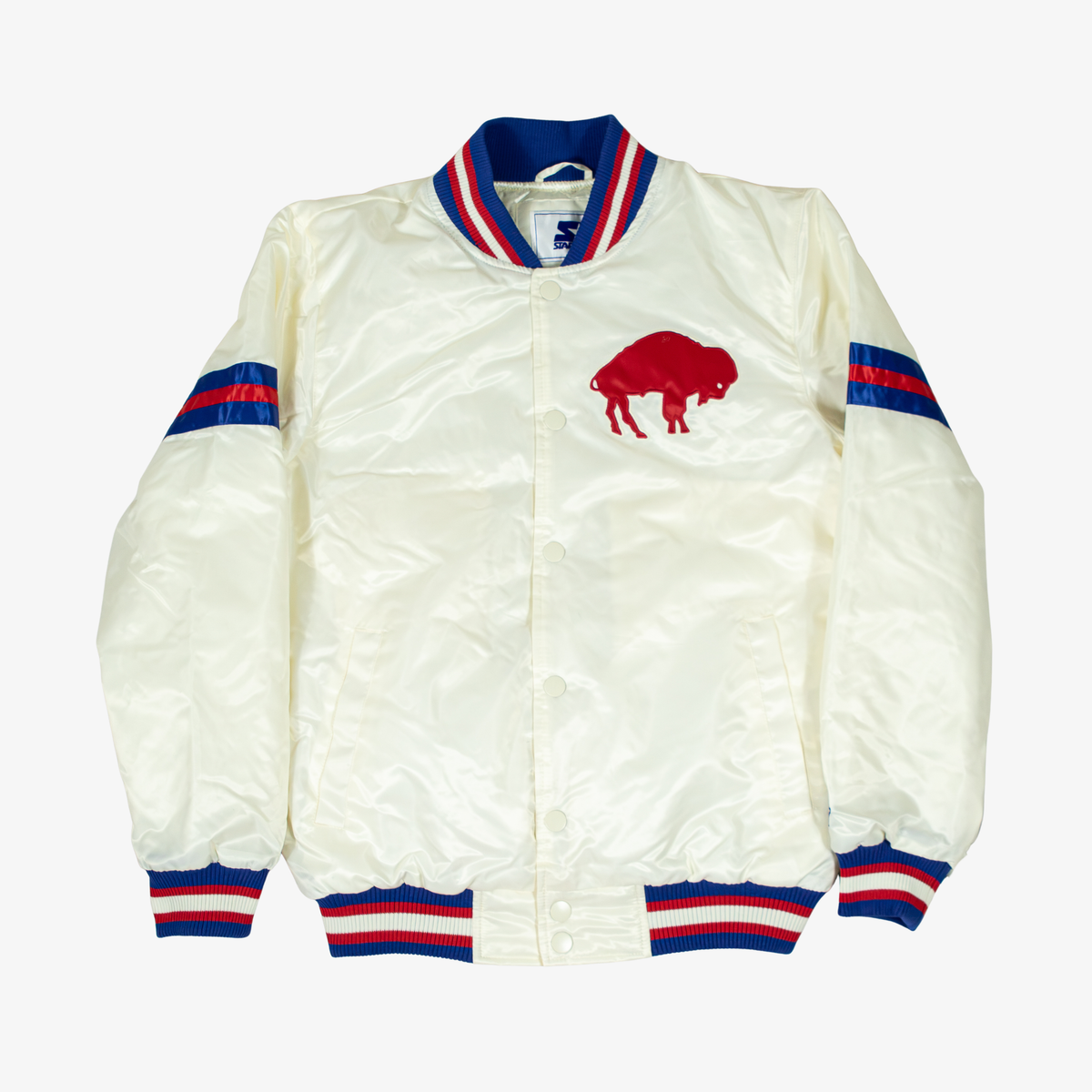 Starter Buffalo Bills cream satin varsity jacket featuring a red standing buffalo chest logo, royal blue and red sleeve stripes, snap-button front, and striped rib-knit trim.