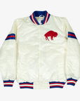 Starter Buffalo Bills cream satin varsity jacket featuring a red standing buffalo chest logo, royal blue and red sleeve stripes, snap-button front, and striped rib-knit trim.