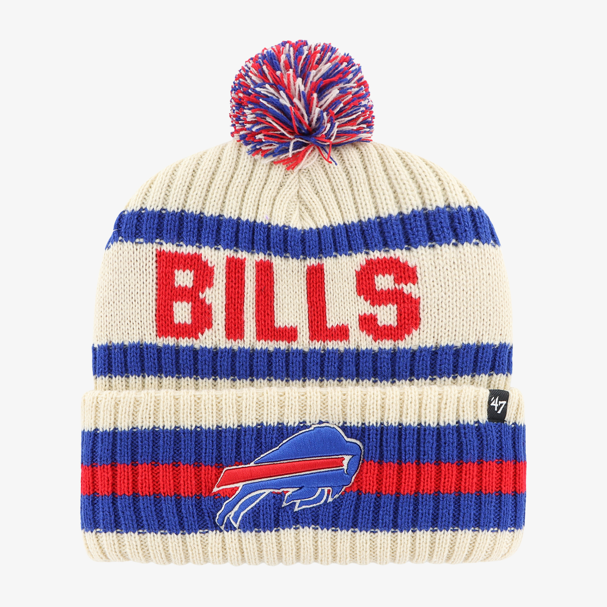 '47 Brand Buffalo Bills cream knit hat featuring royal blue and red horizontal stripes, large red BILLS lettering, embroidered charging buffalo logo, and multicolored yarn pom.