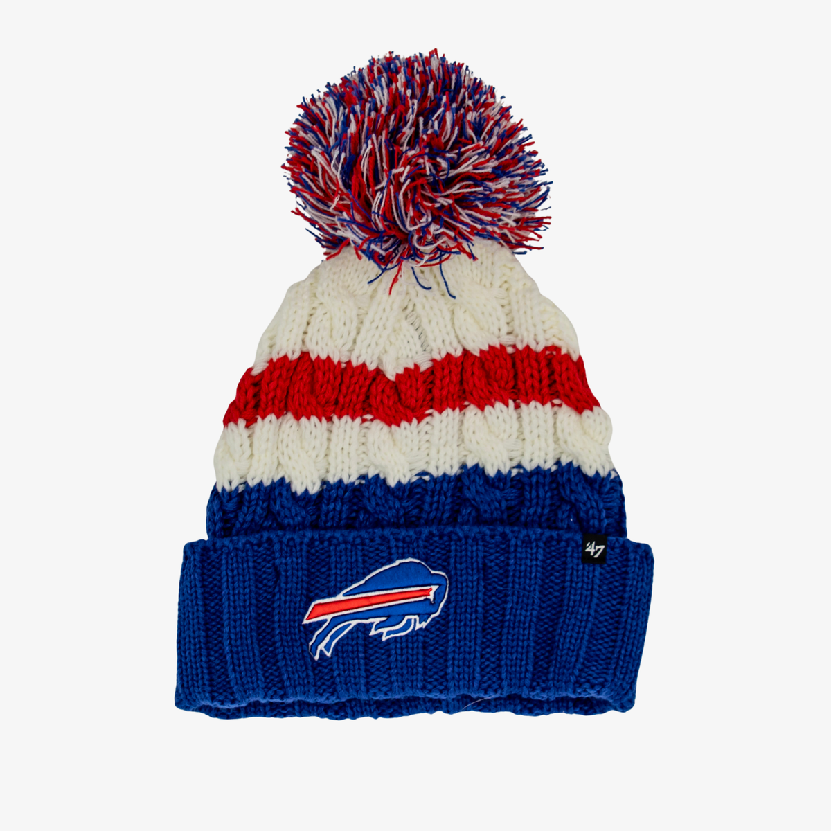 '47 Brand women's Buffalo Bills cable knit beanie featuring royal blue, red, and cream stripes, a multicolor yarn pom, and an embroidered charging buffalo logo on the royal blue cuff.