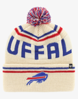 '47 Brand Buffalo Bills cream knit hat with oversized royal blue BUFFALO lettering, red and blue V-shaped stripes, embroidered charging buffalo logo on cuff, and multicolored pom.