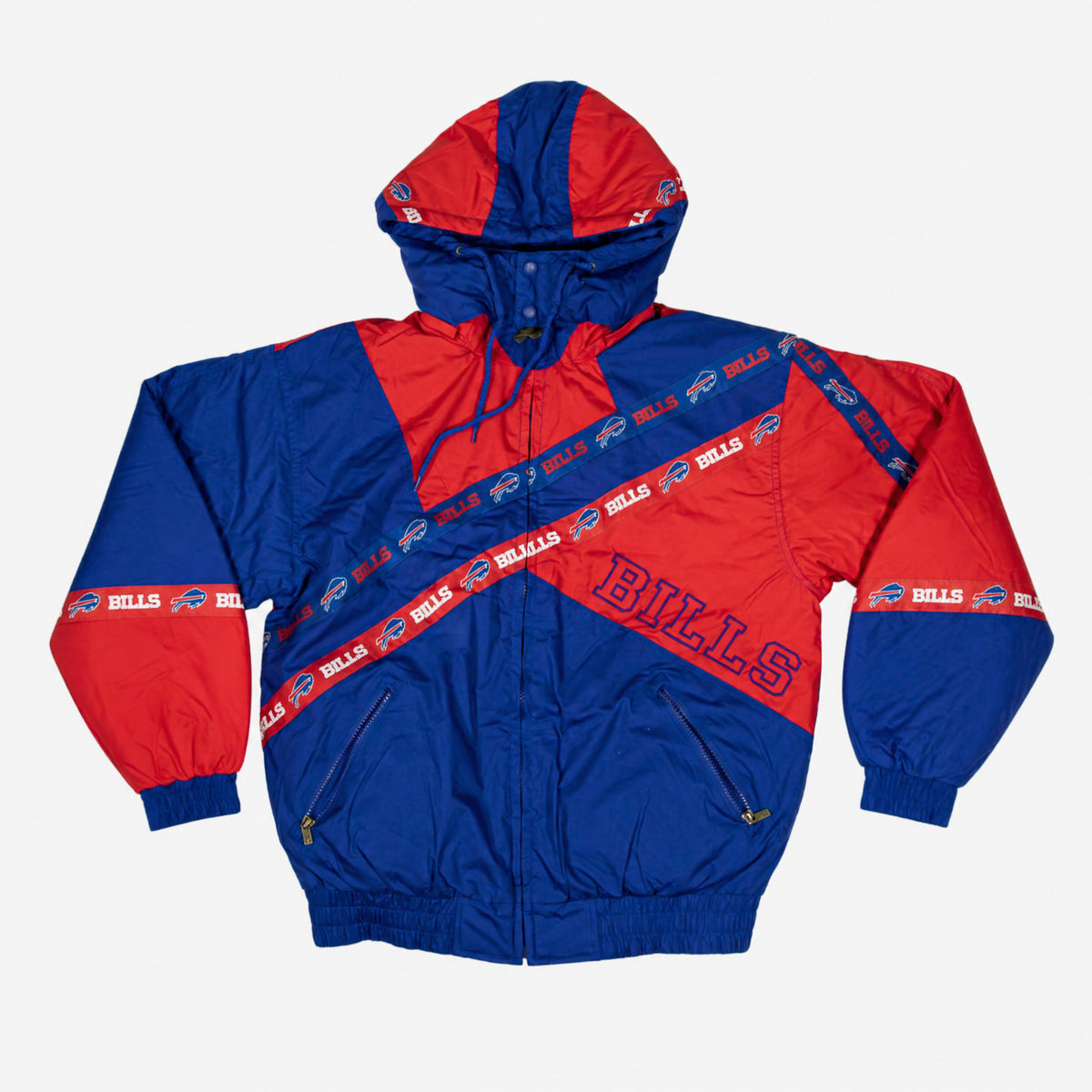 Pro Player Buffalo Bills retro hooded jacket featuring royal blue and red geometric colorblocking, diagonal Bills logo stripes, outlined BILLS lettering, and zippered pockets.