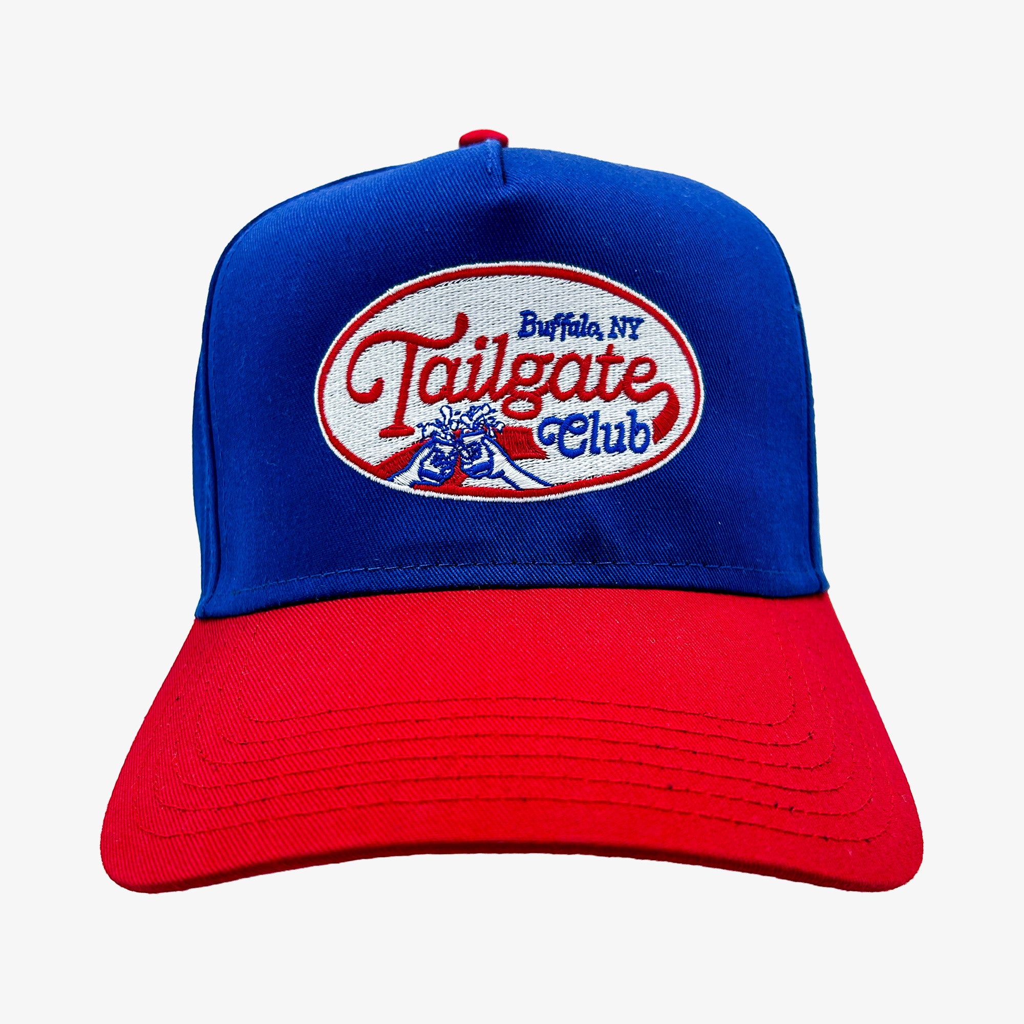 A structured baseball cap with a royal blue crown and a red curved brim. The front features an embroidered oval patch reading 'Tailgate Club' with 'Buffalo, NY' above it and a blue lion graphic.