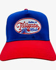 A structured baseball cap with a royal blue crown and a red curved brim. The front features an embroidered oval patch reading 'Tailgate Club' with 'Buffalo, NY' above it and a blue lion graphic.