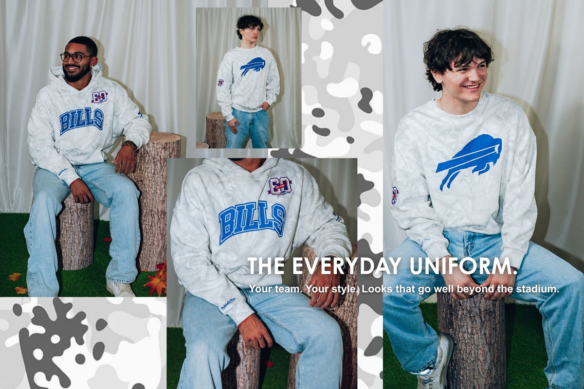 Buffalo Bills men's apparel collection featuring models wearing Mitchell & Ness hoodies and crewneck sweatshirts in white camouflage designs. The Everyday Uniform – Your team. Your style. Looks that go well beyond the stadium. Shop men's Buffalo Bills clothing at The BFLO Store.