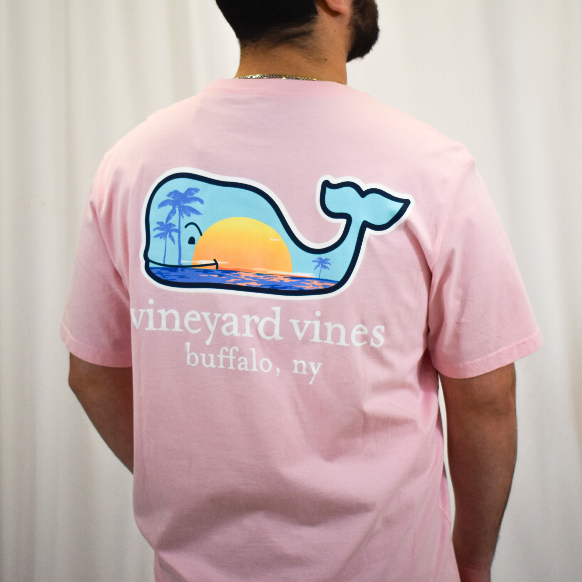 photo of the back of guy wearing a vineyard vines pink showing and showing the whale design