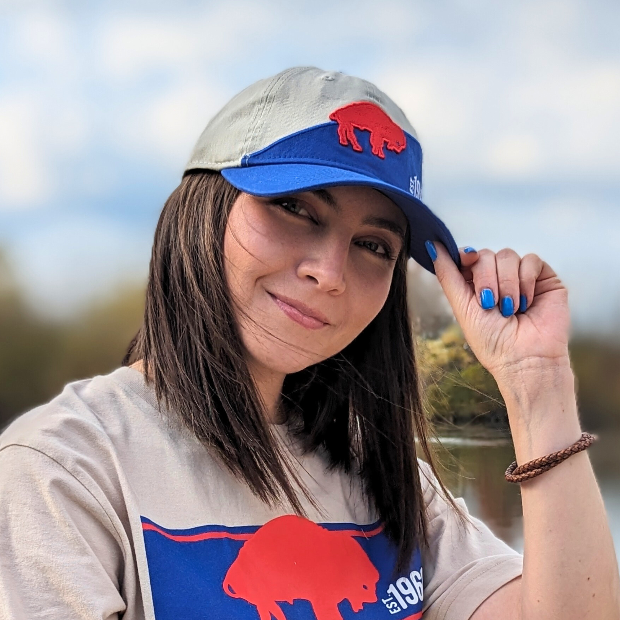 woman wearing a buffalo bills hat with standing buffalo logo