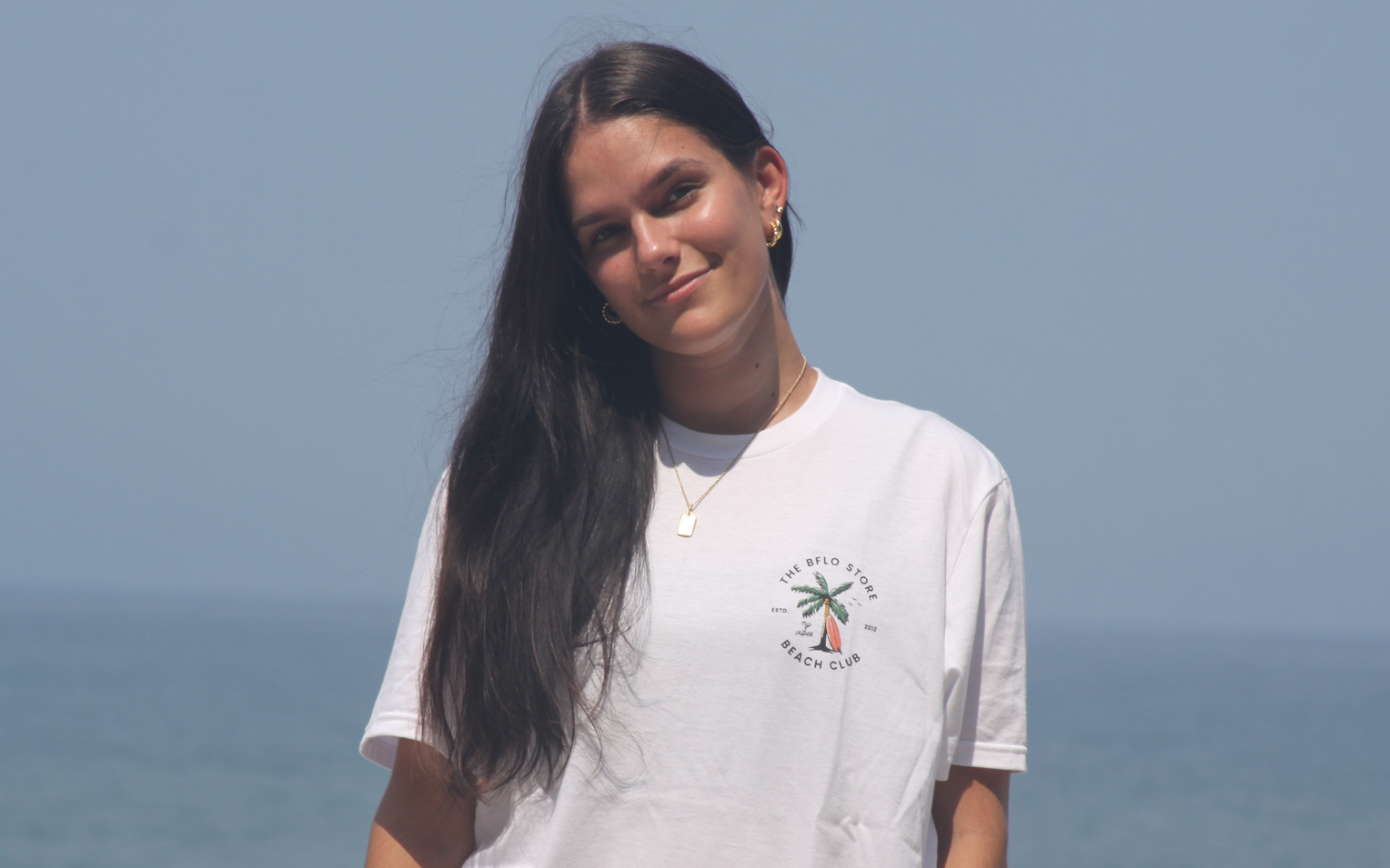 woman wearing a white bflo beach club tshirt